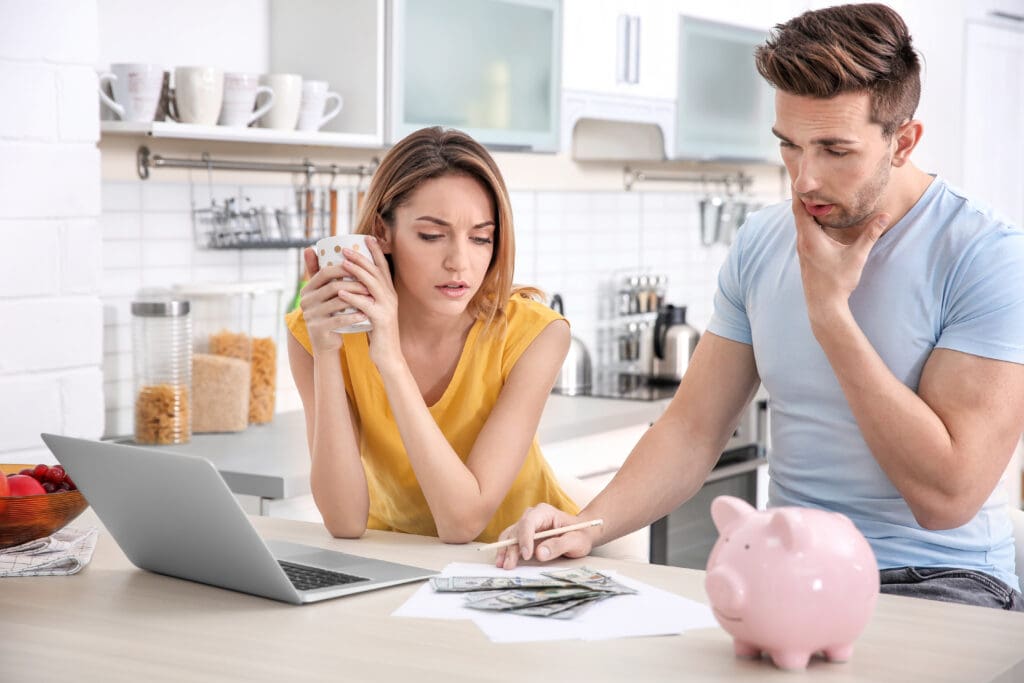two young adults sitting at a table reviewing budget