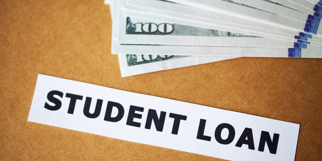 Credit concept. Student loan written on white card.