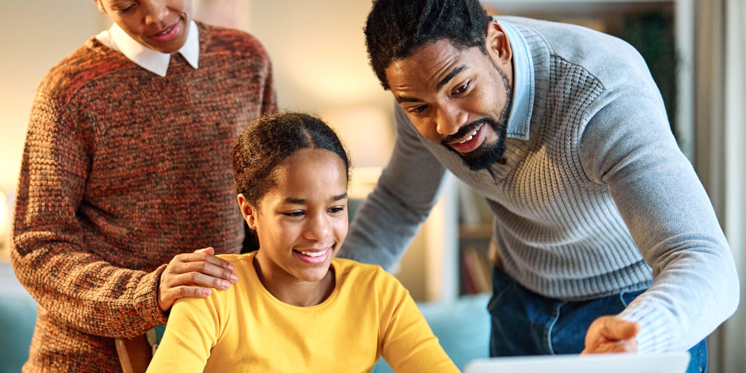 Parents with teen going over financial literacy